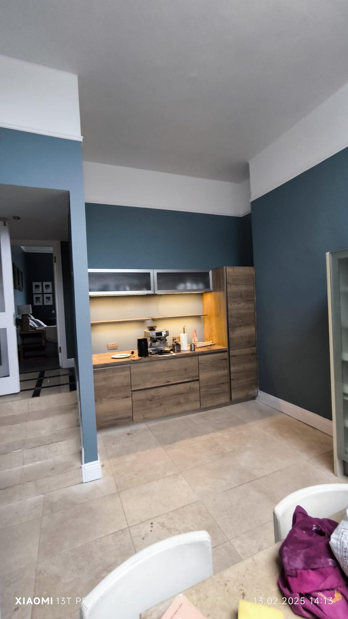 Elegant checkerboard hallway with chandelier